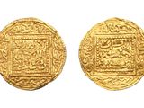 a gold coin with a design on the front and back of it