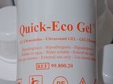 a bottle of quick - eco gel sitting on top of a pile of white cups