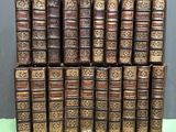 several old books stacked on top of each other on a table