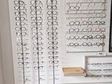a display of glasses on the wall in a store