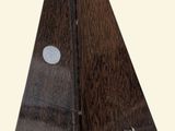 a wooden pyramid shaped object with holes in it