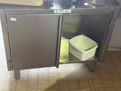 a stainless steel cabinet with a sink and a trash can in it