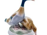 a figurine of a duck and a duckling on a plate