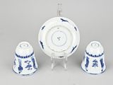 three pieces of blue and white porcelain on a stand