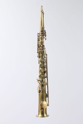 a close up of a saxophone hanging from a string