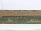 a small green box with two metal handles on a white table