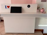 a white desk with a laptop on top of it