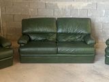 trois chaises en cuir vert et un fauteuil inclinable dans une pièce