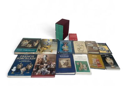 several books are stacked on top of each other on a white surface