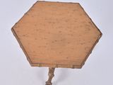 a small table with a wooden top on a white surface