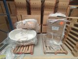 many boxes and baskets on a pallet in a warehouse