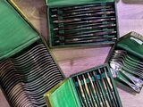 a lot of different colored pencils in a green case