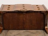 a small wooden chest sitting on top of a wooden floor