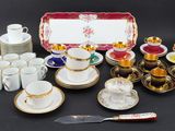 many different types of coffee cups and saucers on the table