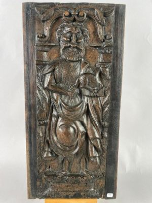an old bronze plaque with a man holding a shield and a sword