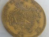a close up of a gold coin with a crown on it