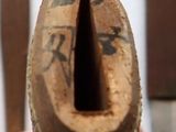 a person holding a piece of wood with a hole in it