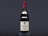 a bottle of red wine sitting on top of a table