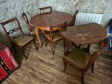 a table and four chairs in the corner of a room