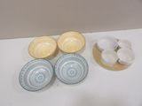 four bowls and two cups on the table