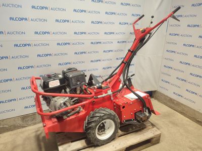 a small red machine that is sitting on a pallet