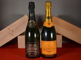 two bottles of champagne sitting next to each other on a table