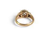 a close up of a gold ring with a diamond on it