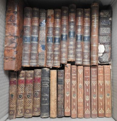 a box full of old books sitting on a shelf
