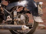 a motorcycle that is parked in front of a brick wall