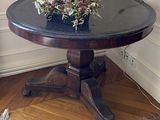 a small table with a vase of flowers on top of it