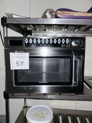a microwave sitting on a shelf in a kitchen