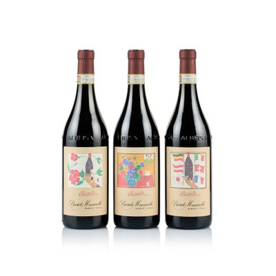 trois bouteilles de vin rouge sont alignées sur une surface blanche