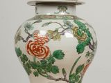 a vase with a lid sitting on a table