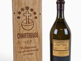 the bottle of chartreuse is next to a wooden box