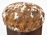 a brown and white cow print stool with a wooden base