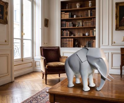 a statue of an elephant on a table in a living room