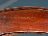 a close up of a wooden chair with a name engraved on the back