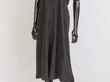 mannequin dressed in a black dress on a glass stand