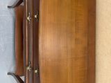 an image of an old wooden dresser with drawers