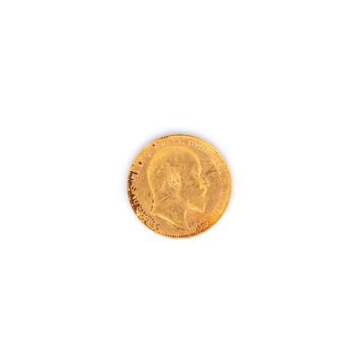 gros plan d'une pièce d'or sur une surface blanche