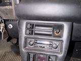 a dashboard of a car with a clock and radio in it