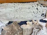 a lot of laces on a table with a teddy bear