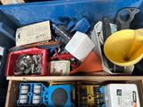 a blue bin filled with assorted tools and other items