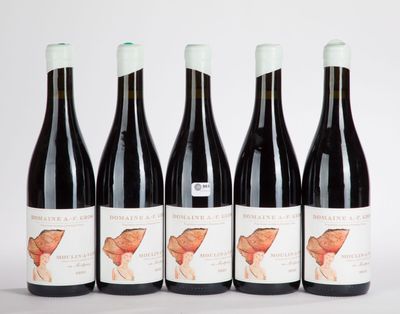 four bottles of wine are lined up on a white surface