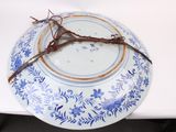 a blue and white plate with a crown of thorns on it