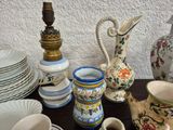 many different types of vases and plates on the table