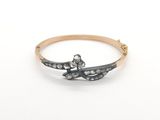 a close up of a gold and diamond ring on a white background
