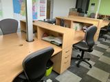 a desk with two chairs and a desk top with a map on the wall