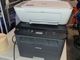 a printer sitting on top of a printer on a table