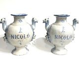 pair of blue and white vases sitting on top of a white surface